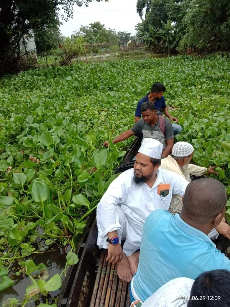 Relief Boat Navigating Through Flooded Assam Rivers